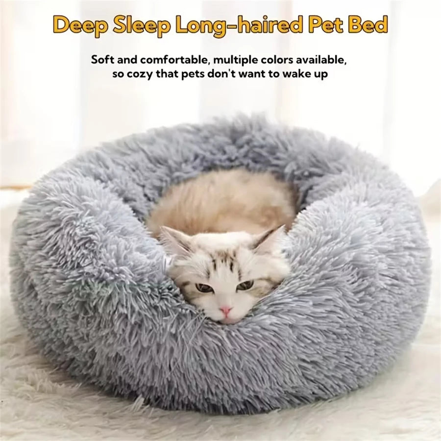 Cat curled up in a grey calming donut bed